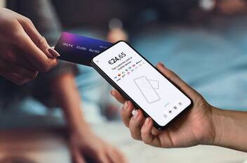 Card tapped on a smartphone accepting payment with Viva SoftPOS